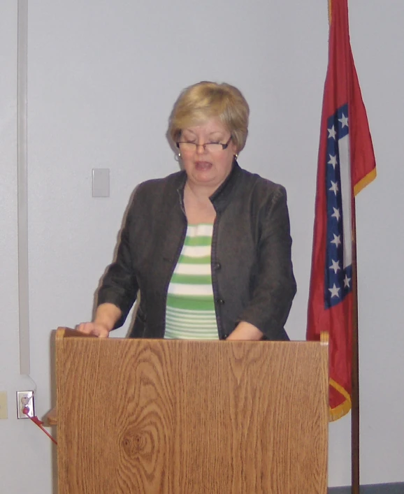 a lady giving a presentation at a podium