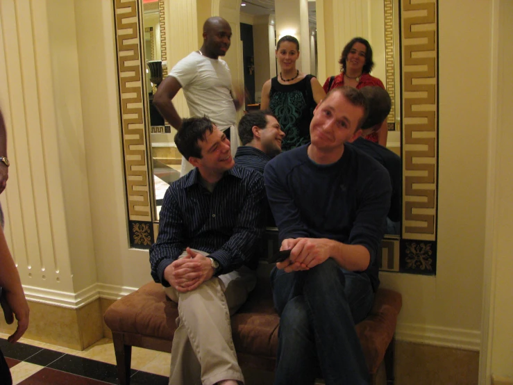 a group of young people sitting in front of mirrors