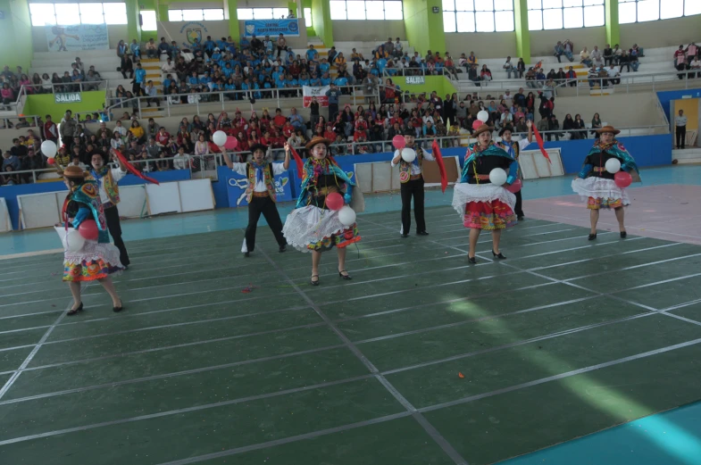 a group of young women performing in costume