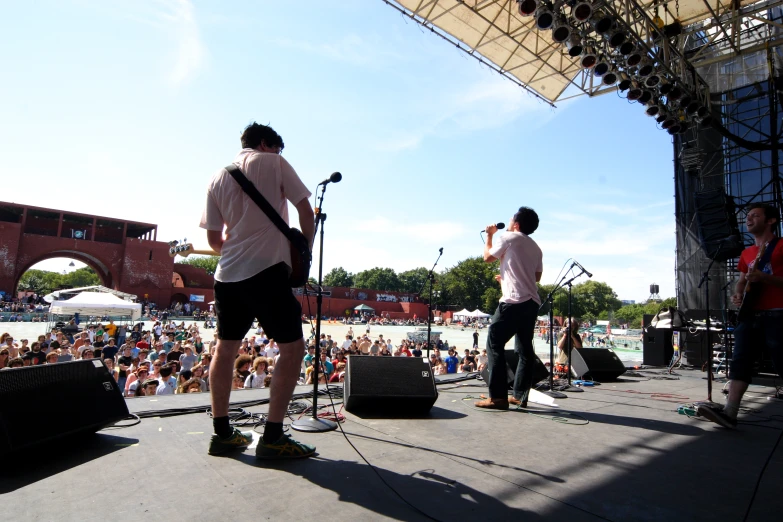 two men playing music at an outdoor festival