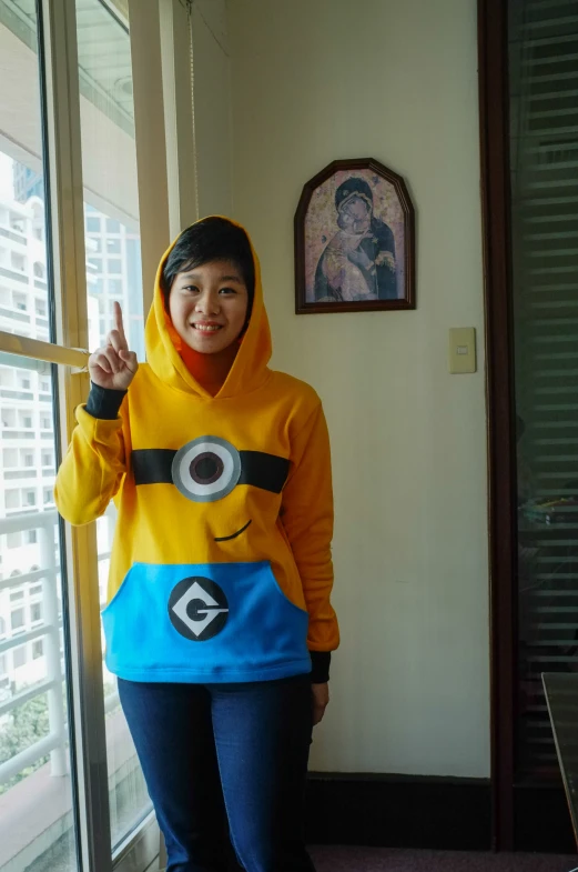 a person in a minion sweatshirt pointing