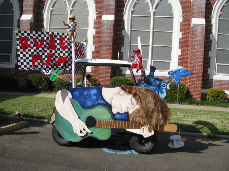 a decorated vehicle sitting in front of an old church