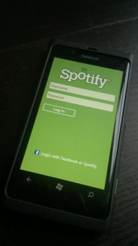an image of the spotify logo displayed on a phone