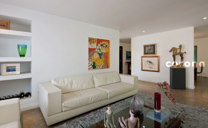 a white couch sitting in a living room on top of a hard wood floor