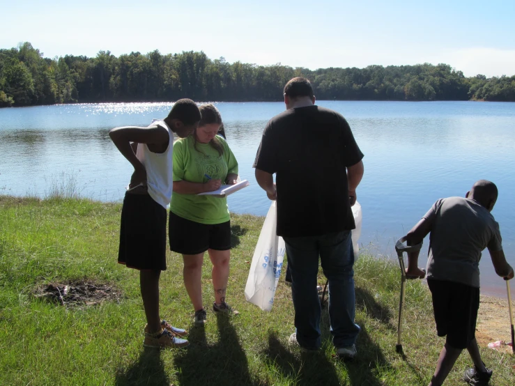 people gathered around the lake to talk