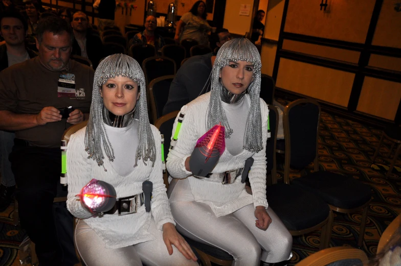 two women in costumes sitting on a chair