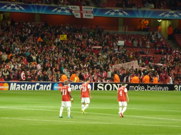 some soccer players standing on the field at the game