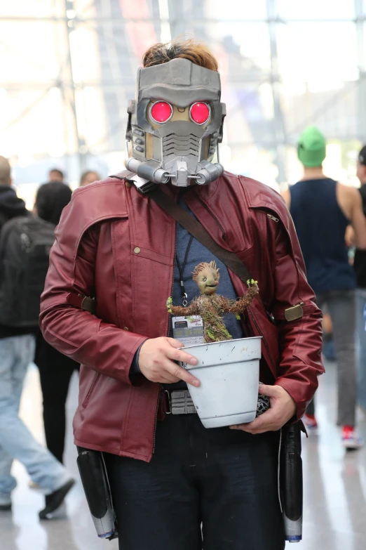 a man in a red leather jacket and mask