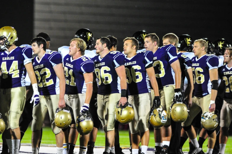 the football team watches their surroundings for the time out