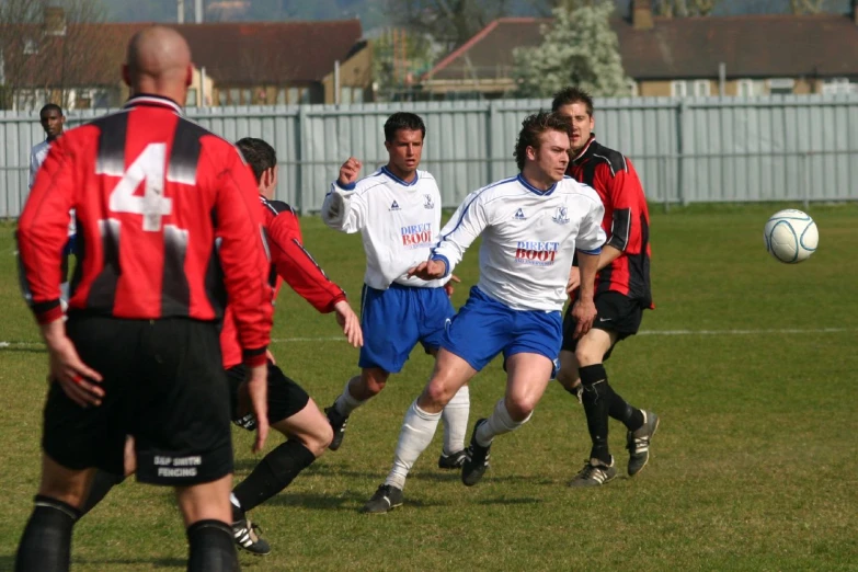 a group of men playing soccer on a field