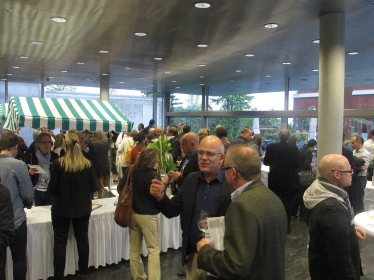 large group of people eating out of food buffet tables