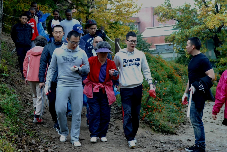 several men walking along a dirt road near trees