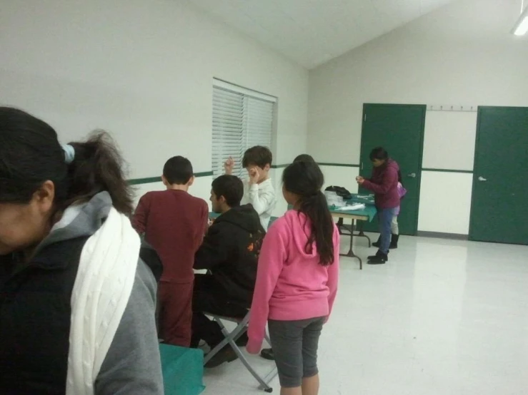 a group of s in a classroom learning on computers