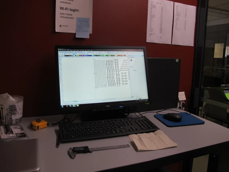 this computer desk holds a large monitor and keyboard