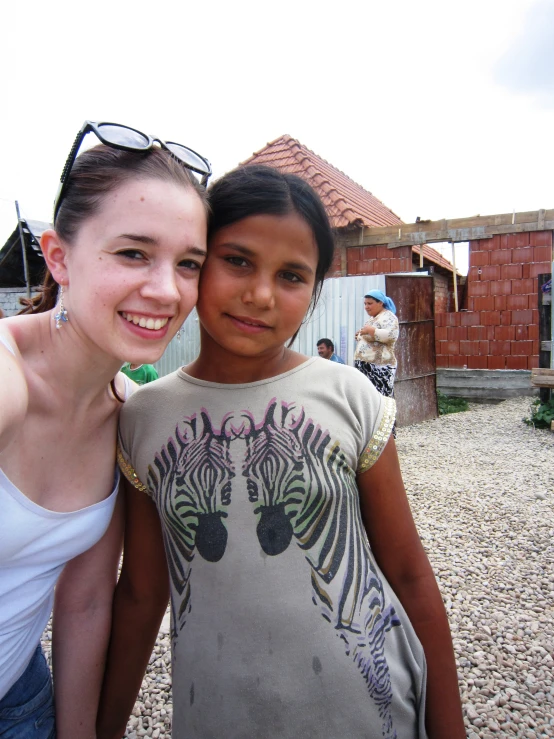 two women standing next to each other smiling