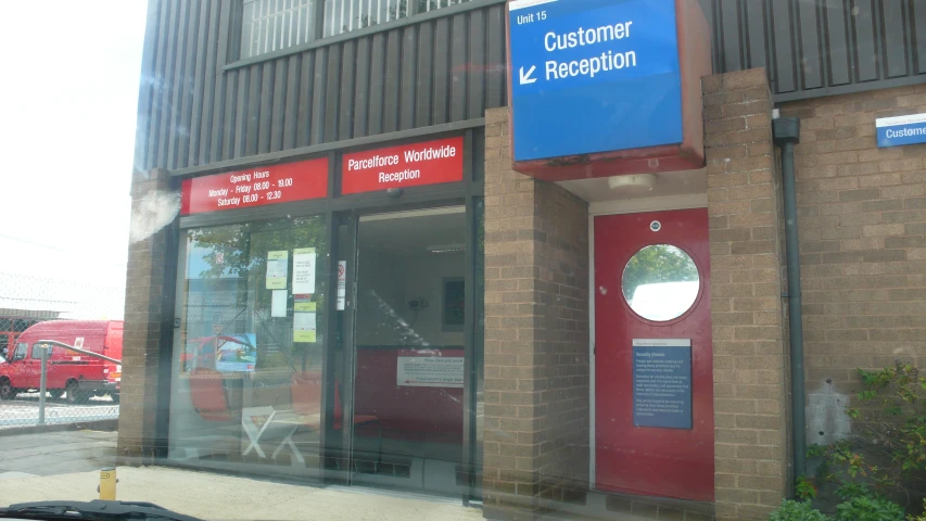 a building with doors, windows, and sign on the outside