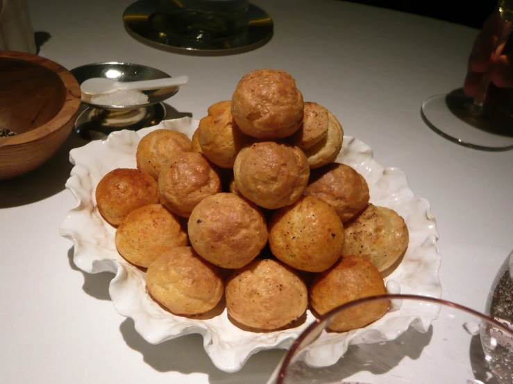 a pile of donuts on a white plate