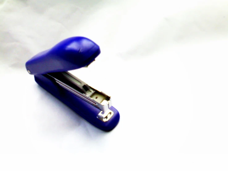 a blue hair clipper sitting on top of a white table