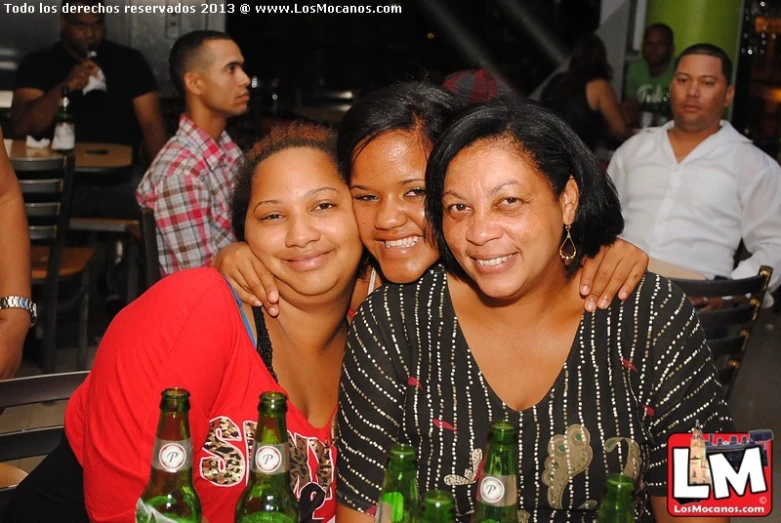 two women with their arms around each other as they look at the camera