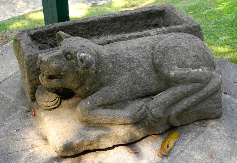 an image of a sculpture of a cat sitting on top of cement