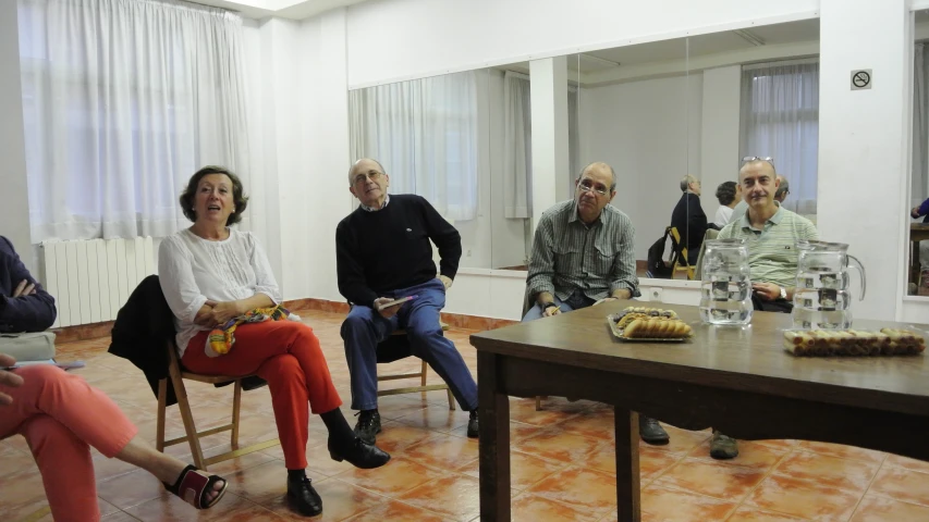 four people sitting together for a meeting with food