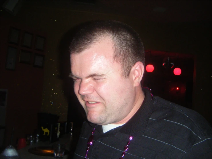 a smiling man at a party wearing a string