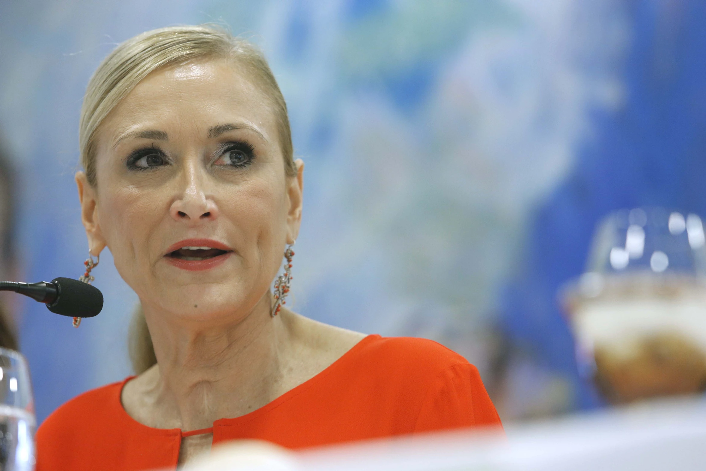 a woman wearing a red dress and holding a microphone