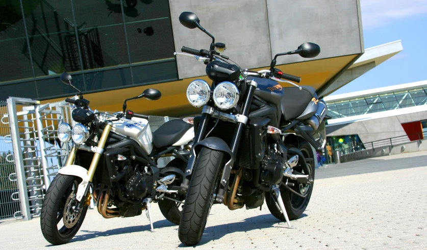 two motorcycles parked outside of a building