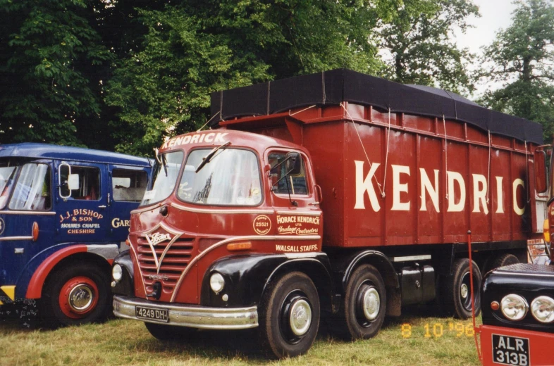 two old trucks, one in red and one blue