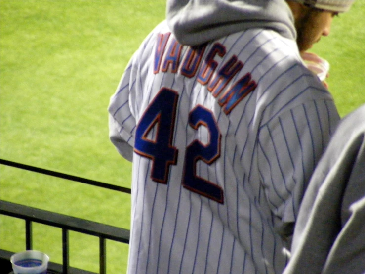 a man with his jersey wrapped around his neck on a baseball field