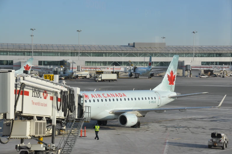 the air canada plane is parked outside of the building