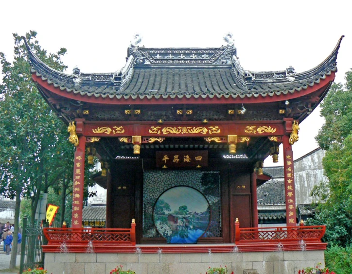 a chinese style building with a large screen on the porch