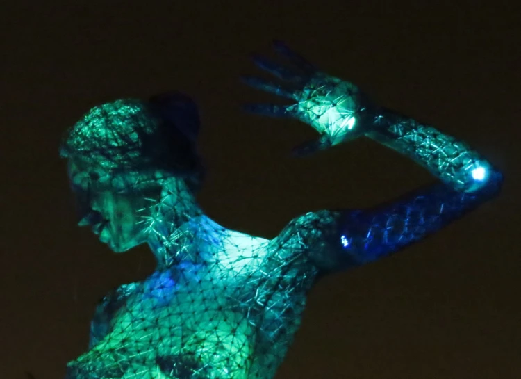 a statue with neon lights painted on its body