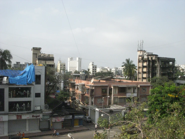 a street with tall buildings and people walking through it