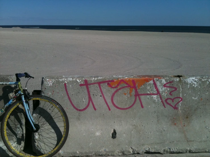 a bike  to a concrete wall next to the ocean