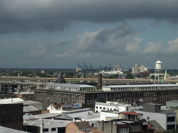 a view of buildings, sky, and clouds from high up