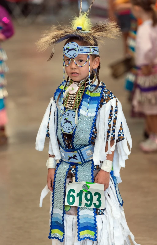 the small boy is dressed in an elaborate costume