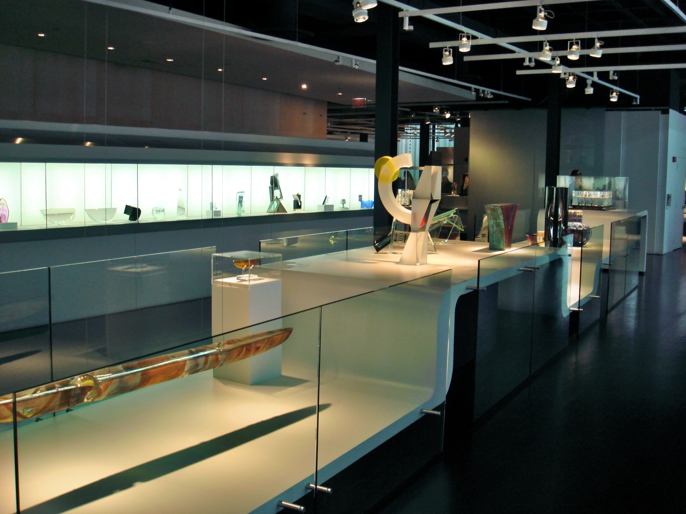 a museum filled with glass counter top next to a wall