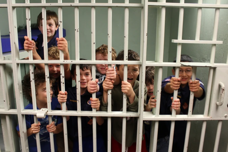 a group of s holding their fists behind bars