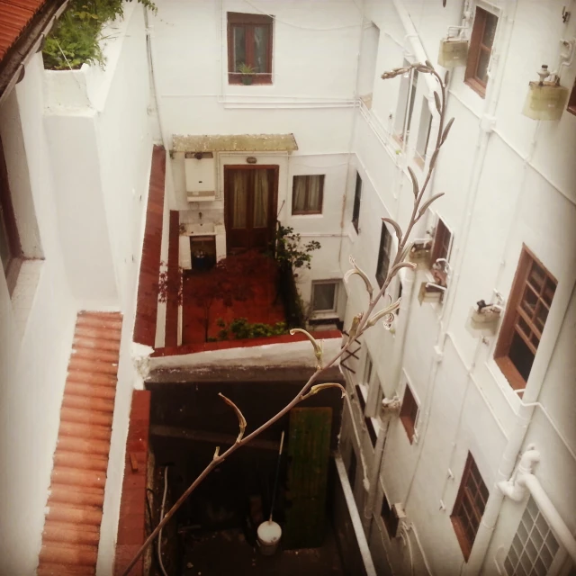 a view from the top of a room to a stairway and small building