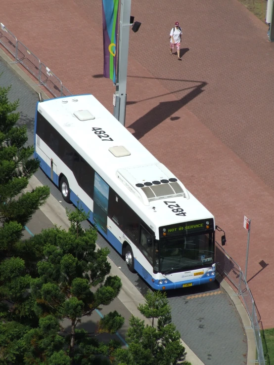 a blue and white bus parked at a parking lot