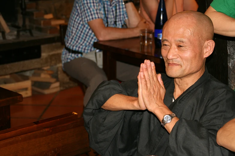 a man in black shirt with arms folded up