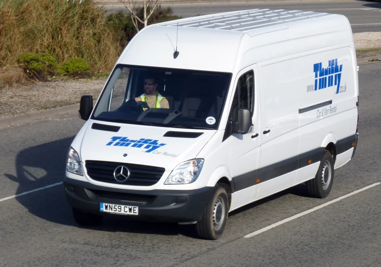 an airport service van driving on the highway