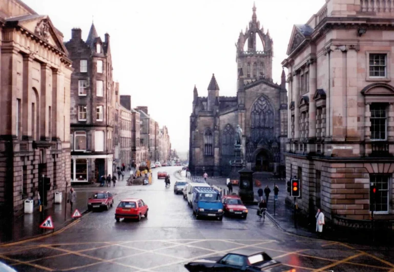 a group of cars that are driving down a street