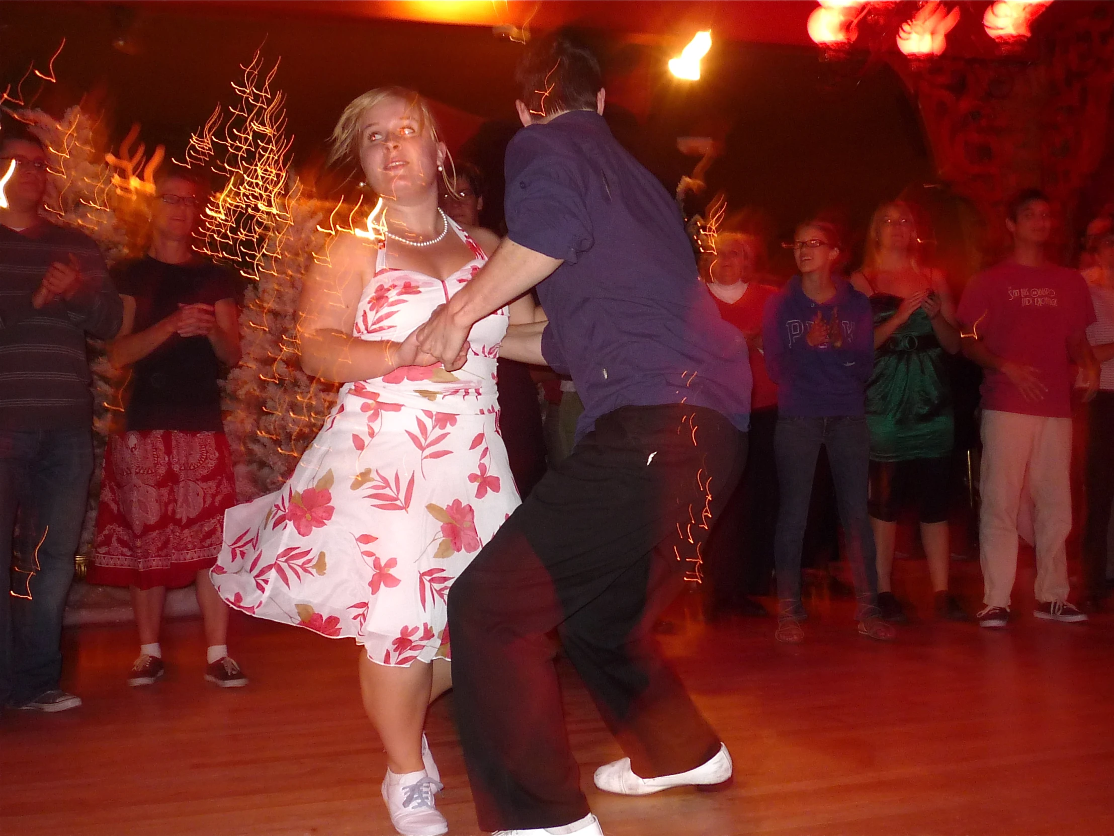 a man and woman dancing in an indoor setting