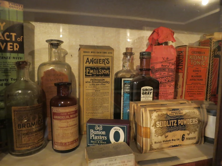 a shelf with old medicine bottles on it