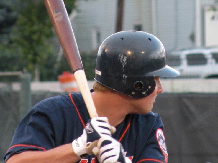 a baseball player is holding a bat