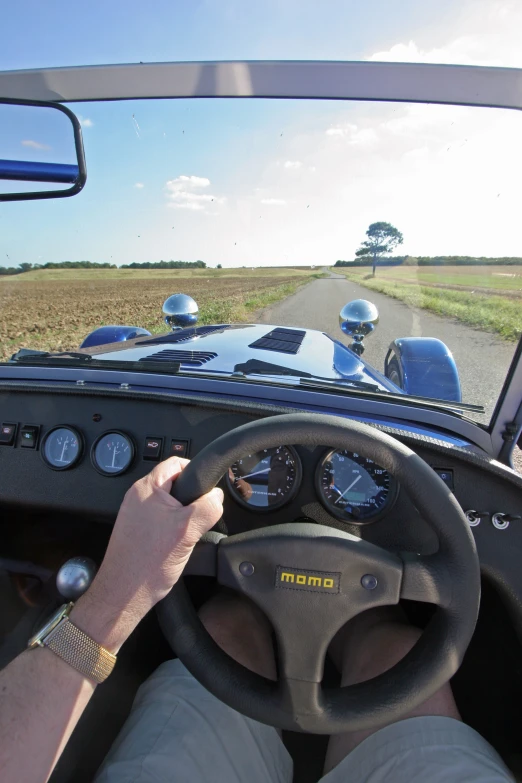 the driver is driving on the road while the other car watches