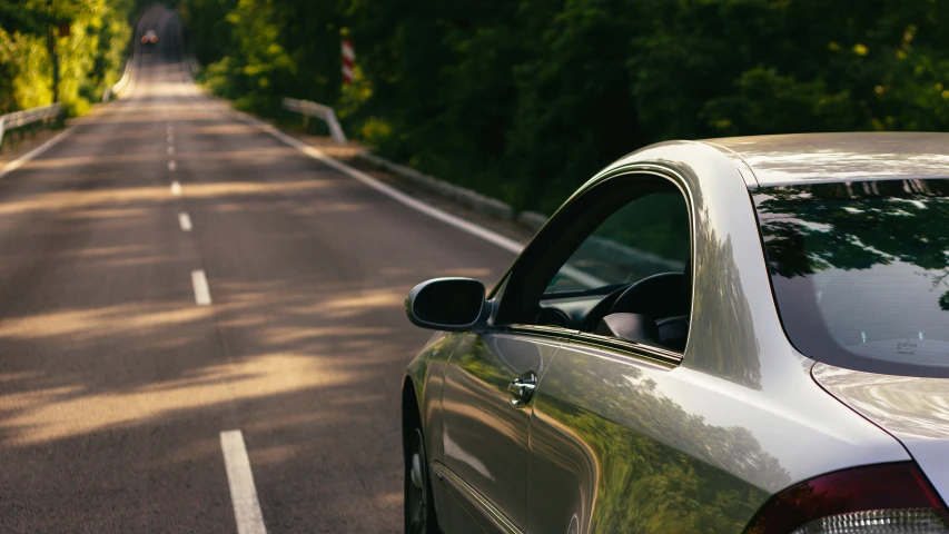 a white sports car is parked on the side of the road