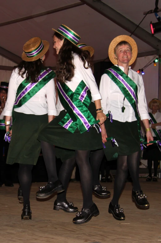 a group of people with hats on and some wearing skirt